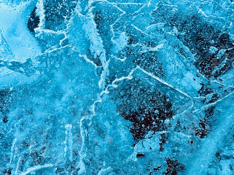 Frosty patterns on the edge of a frozen window.