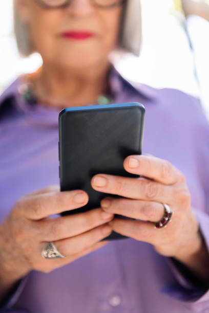 istock unrecognizable senior woman using mobile phone 2028847837