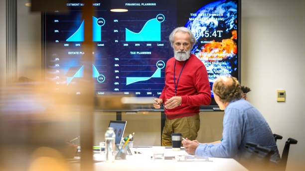 istock Senior man presenting report in meeting room 2028848902