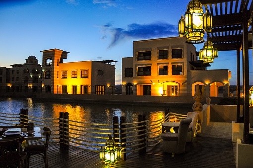 Marsa Alam, Egypt - April  20, 2010: Illuminated hotel at night near a large pool of water, Port Ghalib, Marsa Alam, Red Sea