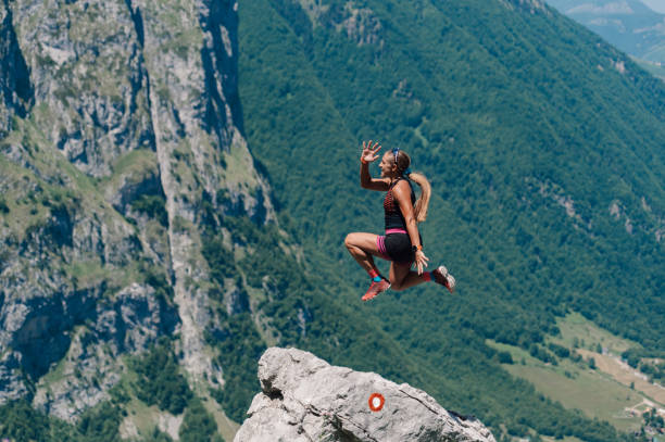 istock A skyrunner is jumping high and practicing in mountains. 2028853377