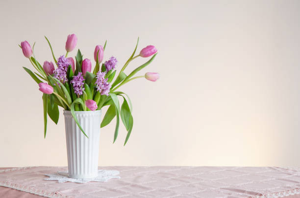 istock spring flowers in white vase in vintage style 2028858459