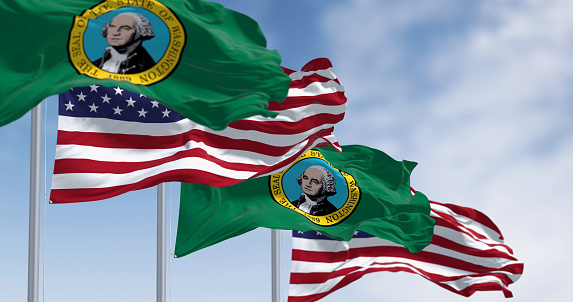 Washington state flags waving with the american flags. Dark green field with a seal showing the picture of George Washington in the middle. 3d illustration render. Rippling fabric. Selective focus