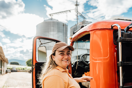 Female truck driver at agricultural silo