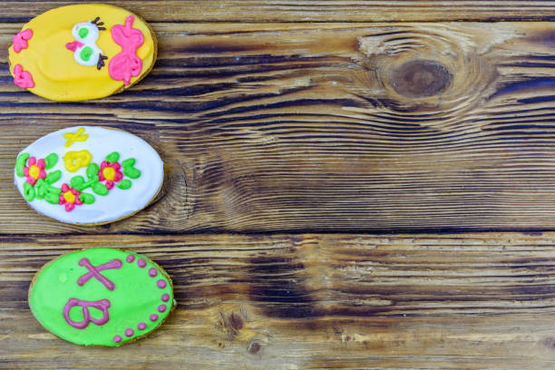 Easter cookies in plate on wooden background. Top view