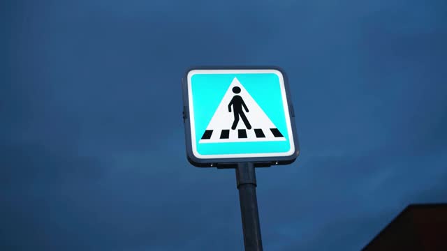 Pedestrian crossing roadsign stock video