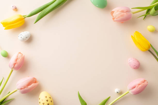 istock Step into Easter spirit with captivating top view display of lively eggs, cute bunny ears, and fragrant tulips against neutral backdrop. Spacious frame invites your personalized text or promotion 2028992820