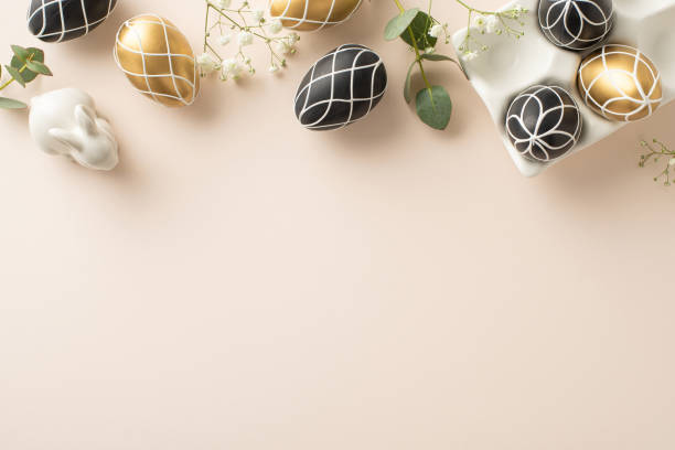 istock Elegant Easter arrangement: top view perspective of chic black and gold eggs in earthenware container, bunny ornament, eucalyptus greens, gypsophila, on a soft beige foundation, blank space for text 2028992823