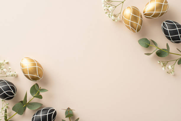 istock High-end Easter arrangement: Top view photo capturing elegant black and gold eggs, verdant eucalyptus leaves, gypsophila accents, organized on beige background, space reserved for text or advertising 2028992837