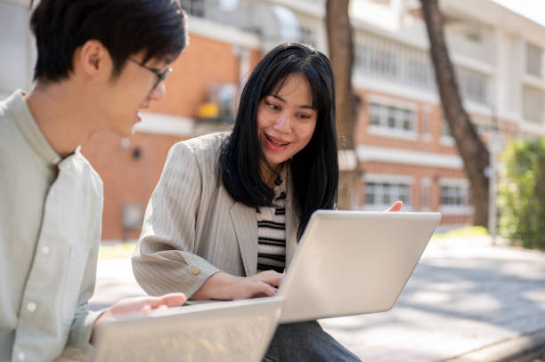 istock A friendly Asian female student is discussing work and helping her friend with math homework. 2029101986