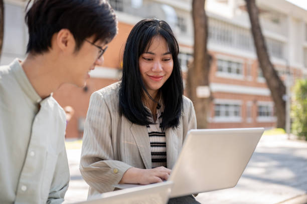 istock A friendly Asian female student is discussing work and helping her friend with math homework. 2029101988