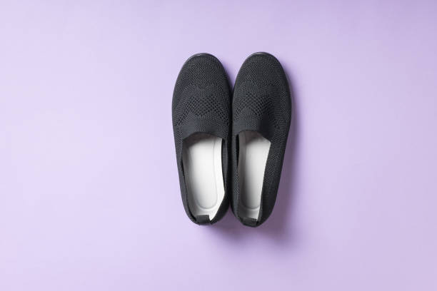 istock Soft black women's shoes on a purple background. 2029124779
