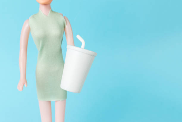 istock A girl with a drink glass on a blue background. 2029124787