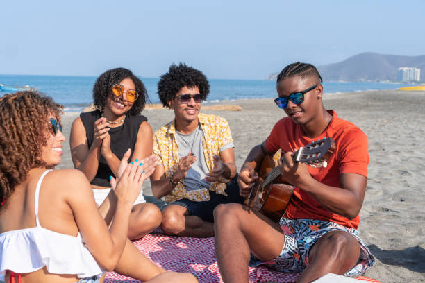 istock Seaside Serenade: Friends Clapping Along to Guitar Music 2029127897