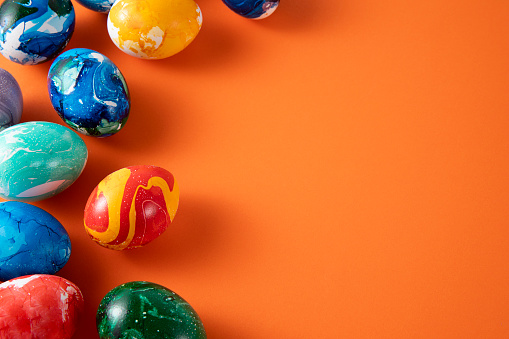 Happy Easter with colorful eggs at paintbrush for do it yourself on the grass with close up from top view.