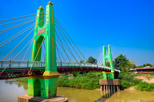 istock Green suspension bridge across Nan River at Chum Saeng District 2029151682