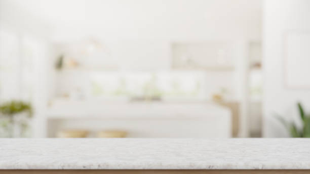 istock A copy space on a white marble tabletop with a blurred background of a modern white kitchen. 2029175318