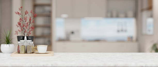 istock Empty space on a white tabletop with a blurred background of a contemporary kitchen. 2029180700