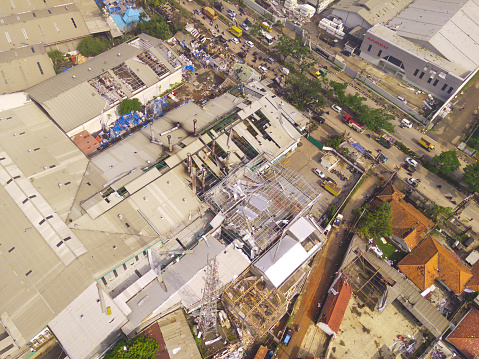 Damage to roofs and buildings in the Dwipapuri and Kahatex industrial areas due to tornadoes at Rancakek and the Sumedang border on 21/February/2024, Indonesia. Scattered debris causes traffic jams