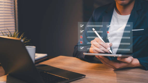 istock Business performance checklist questionnaire, evaluation concept, businessman using laptop doing online checklist survey, digital form checklist and assessment questionnaire online survey 2029202969