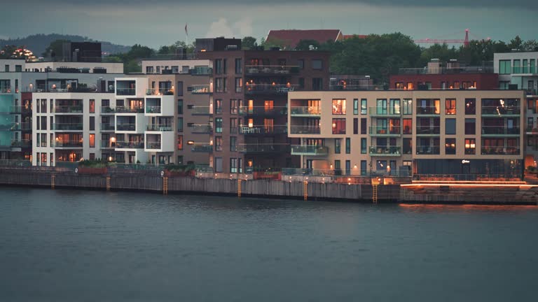 Modern residential buildings with brightly lit windows in the coastal quarter of the Kristiansand city.