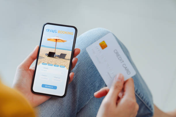 istock Woman hands using credit card for payment on smartphone with application booking flight travel search ticket holiday and hotel on website. 2029293955