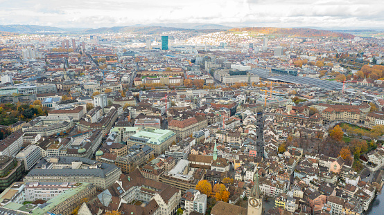 aerial view drone footage of the famous Zurich along the Limmat river international  landmarks such as the Grossmunster cathedral and the lake bridge in Switzerland largest city.