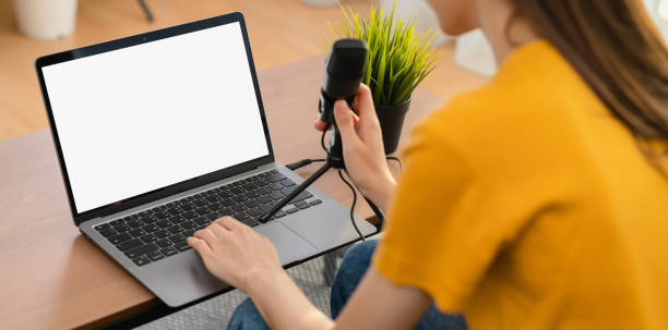 woman hand type on the keyboard on laptop with mockup of blank screen and microphones for record podcast interview for radio. - blog internet podcast computer keyboard imagens e fotografias de stock
