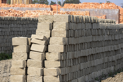A pile of neatly arranged raw bricks in Brickfield in Bangladesh. Raw bricks made of soil are sun-dried before putting into the furnace.