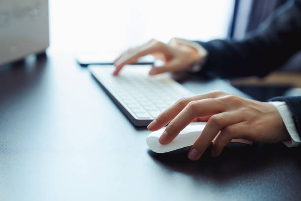 istock Business manager hand using on white mouse with clicking and its apps for customer support, including email, chat, and communication. 2029325368