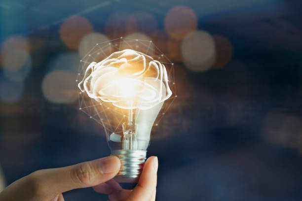 istock Hand holding light bulb with innovation and creativity are keys to success. Concept knowledge leads to ideas and inspiration. 2029328438