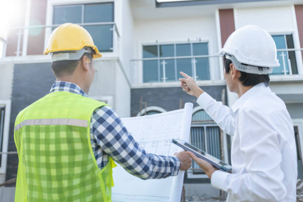 istock inspector engineer and owner project is inspecting construction and quality assurance new house. Engineers or architects or contactor work to build the house before handing it over to the homeowner 2029351257