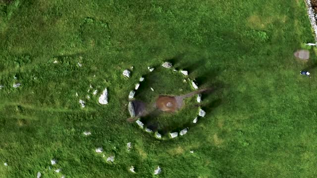 Top down aerial shot looking down on the Drombeg Stone Circle rotating around in a circle in County Cork, Ireland