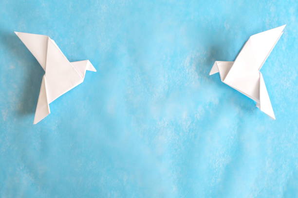 istock Two white dove paper cutout in blue background template with copy space. 2029376234