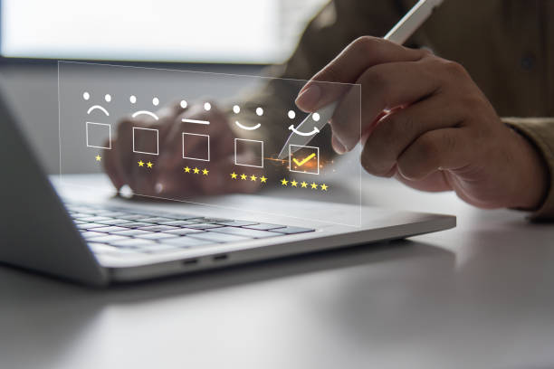 istock customer review interacts with a digital satisfaction online survey on a laptop, selecting a glowing five-star customer service rating and client feedback. Concept marketing information is excellent 2029395145