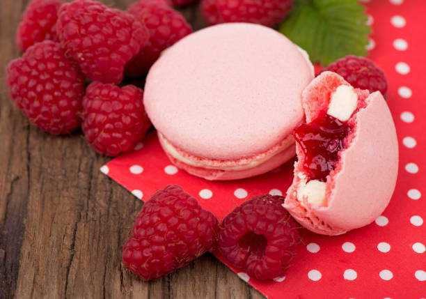 istock Macaroon with raspberries cookies on a wooden background 2029410817