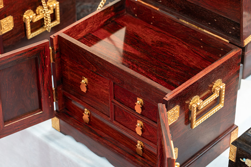 Treasure chest made of gold. Antique chest made of wood and metal, painted gold. Antique padlock locks the treasure chest. on a white background with clipping path. 3D renderingTreasure chest made of gold. Antique chest made of wood and metal, painted gold. Antique padlock locks the treasure chest. on a white background. 3D rendering