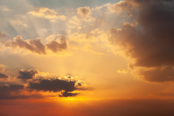 istock Beautiful vibrant orange sunrise sky with sun rays 2029472572