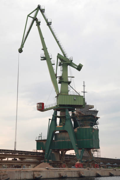 istock Green bulk crane is on the coast at Sea port 2029484322