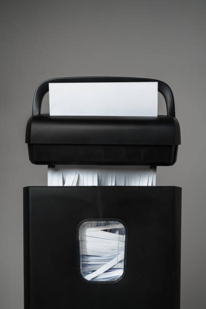 istock Black paper shredder cutting paper on gray background 2029500133