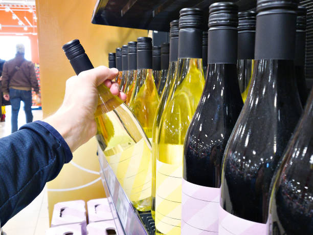 istock Bottle of white wine on hand in shop 2029509161