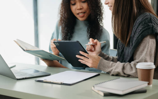 istock Team work process. Photo young business crew working with new startup project. Project managers meeting. Analyze plans, papers. 2029527132