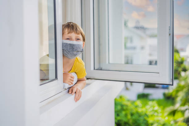 istock Extremly tired boy looking out the window, home alone. self-isolation at home, quarantine due to pandemic COVID 19. Mental health problems in self-isolation at home, quarantine, isolation, stay at home 2029530793
