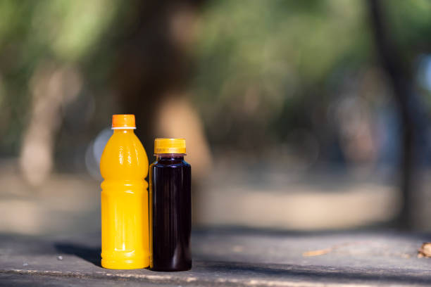 Close up of plastic bottle with juice drink in park