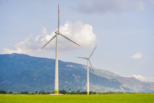 Wind power plant. green meadow with Wind turbines generating electricity.