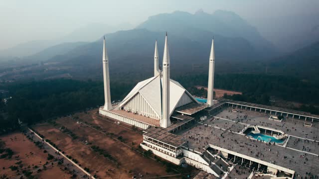 Misty day near the Faisal Mosque in Islamabad with hills in the background, aerial view