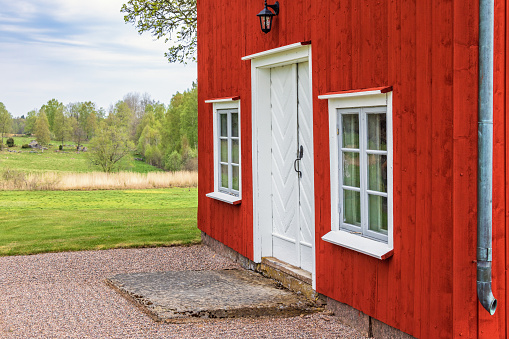 Entrance to an idyllic red house in the countryside