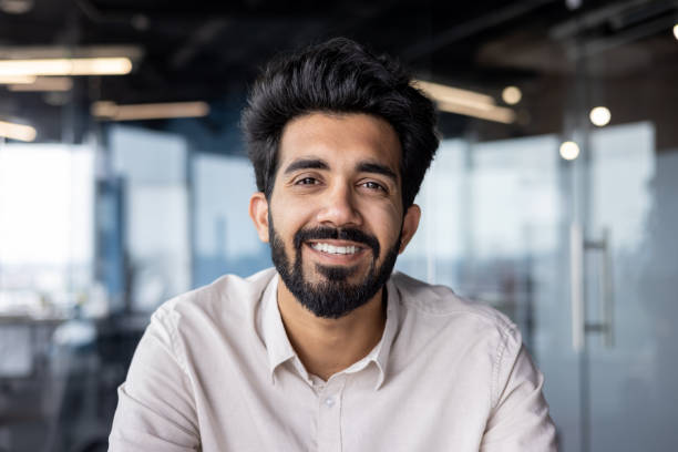 istock Confident indian businessman smiling in modern office environment 2029600847