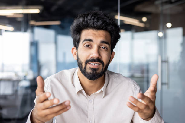 istock Young indian businessman engaging in conversation at modern office 2029600848