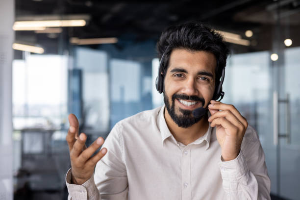 istock Cheerful indian businessman using headset in modern office space 2029600855